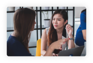 Women talking at a computer